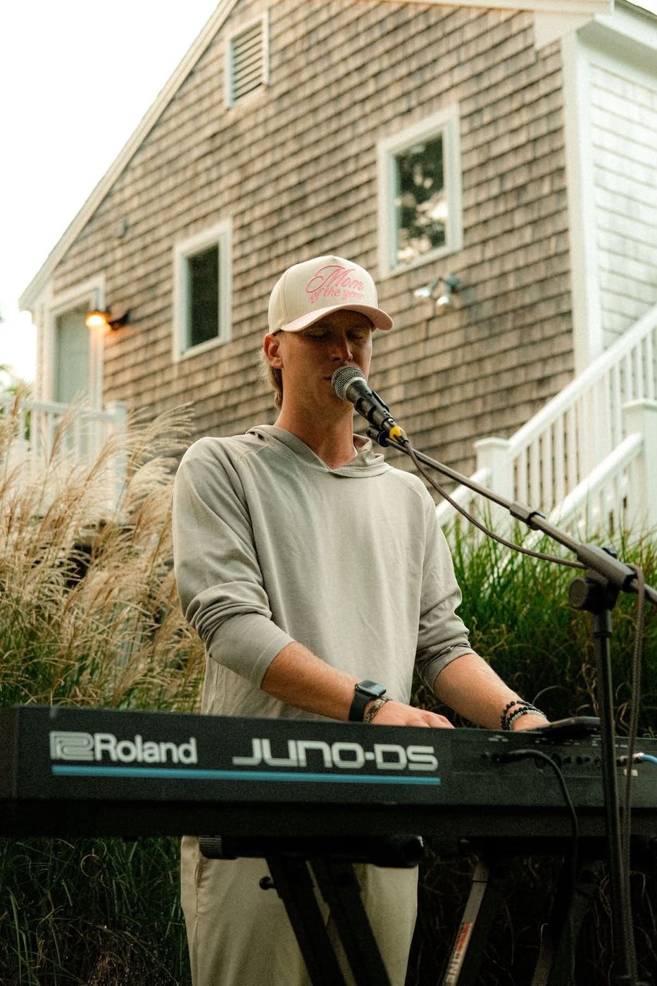 Keyboard player singing at an outdoor show